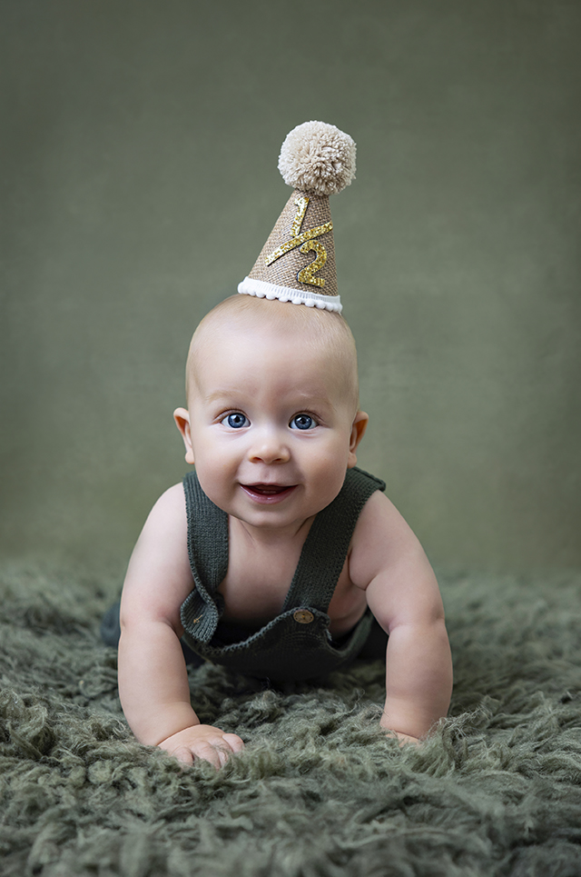 Baby boy wearing a gold birthday hat during a San Ramon baby milestone photography session by FrameIt Bay Area.