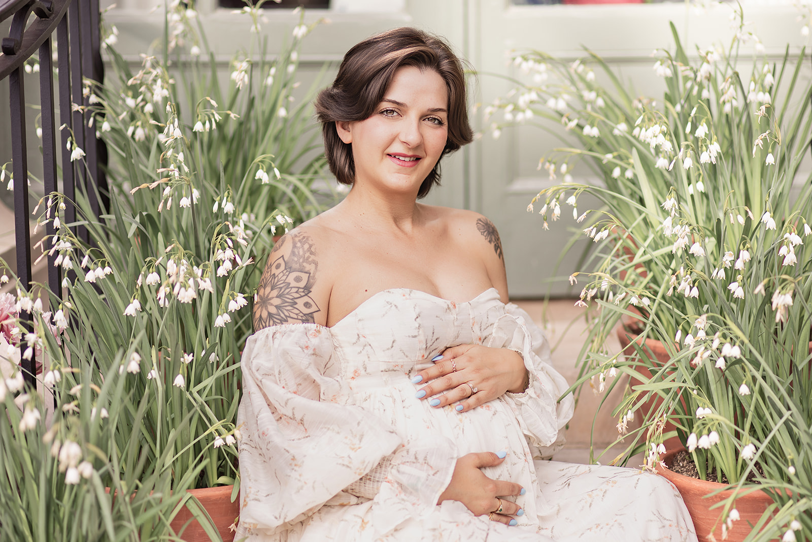 Pregnant woman in white maternity dress posing among flowers at Filoli Garden in the Bay Area — FrameIt Bay Area maternity photography