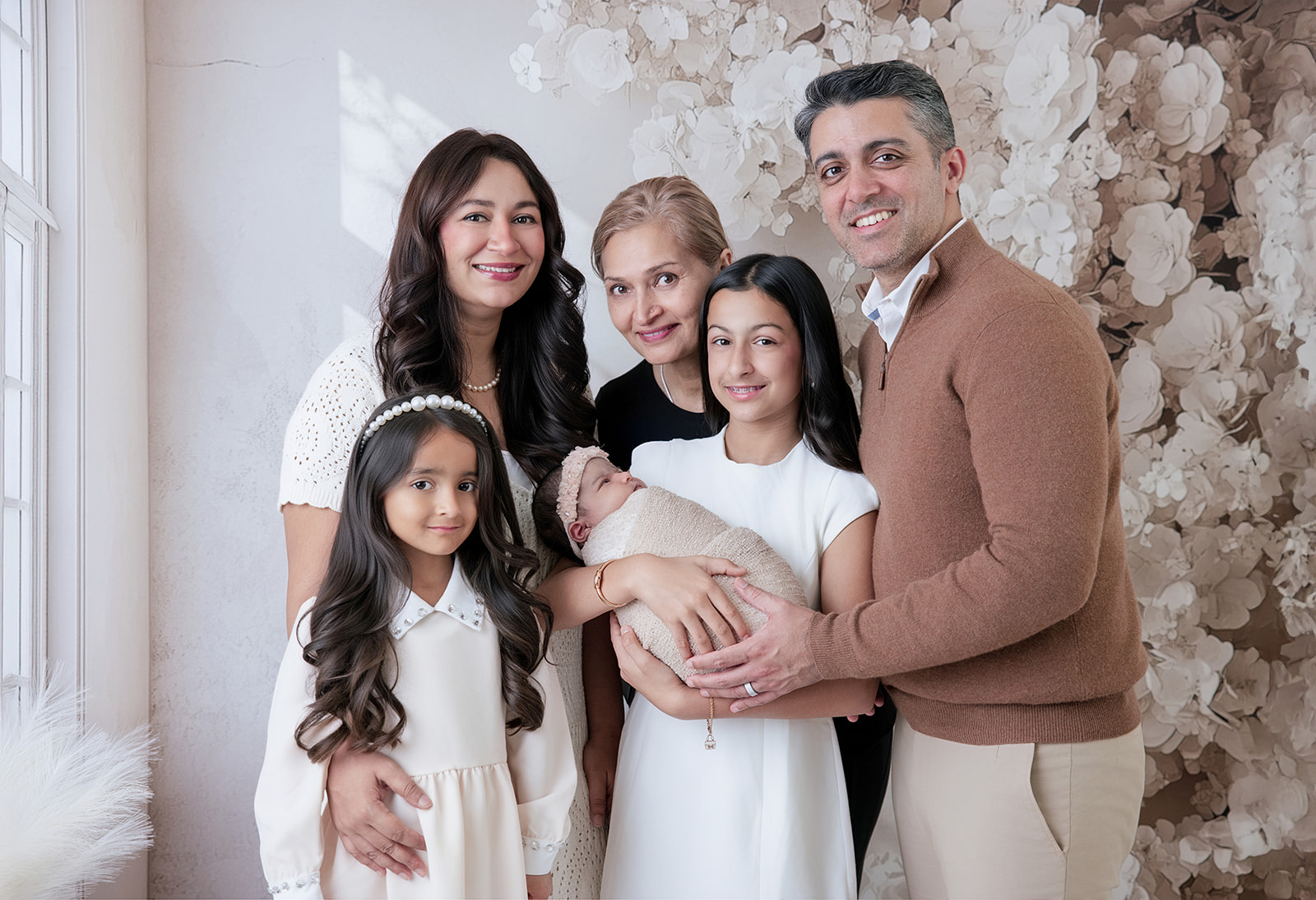 Parents and their three daughters posing together with their newborn baby during a San Ramon family newborn photography session.