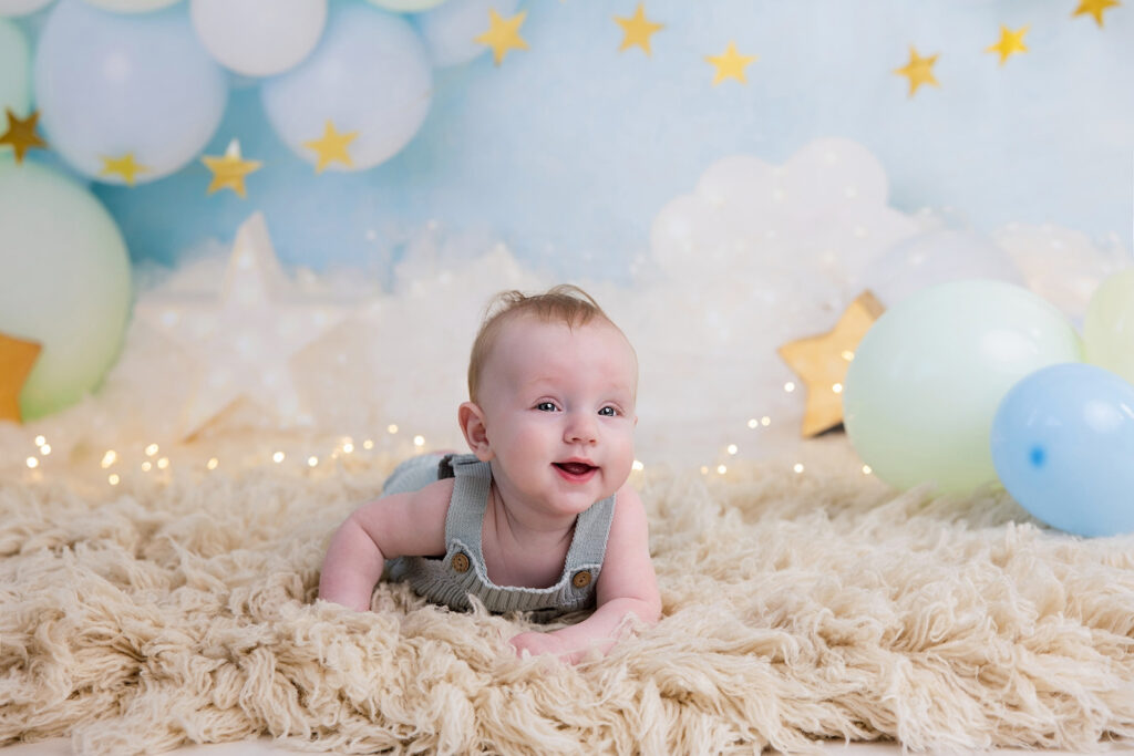six month photos of baby smiling during milestone session