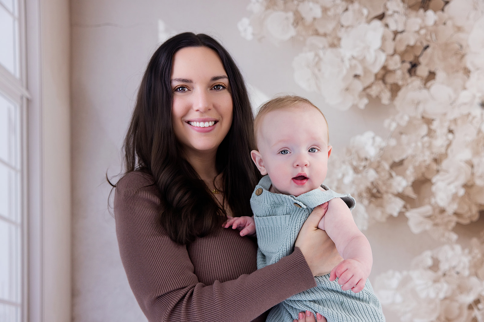 Mother and six-month-old baby smiling together during a baby milestone photography session in San Ramon
