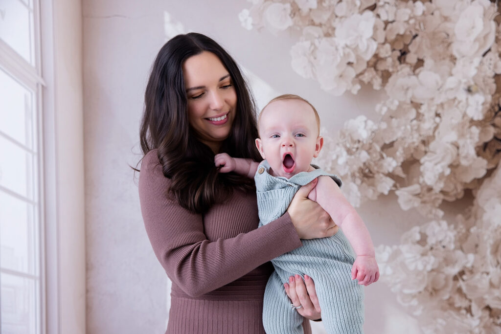 Mother holding her six-month-old baby during a six-month milestone photography session in San Ramon