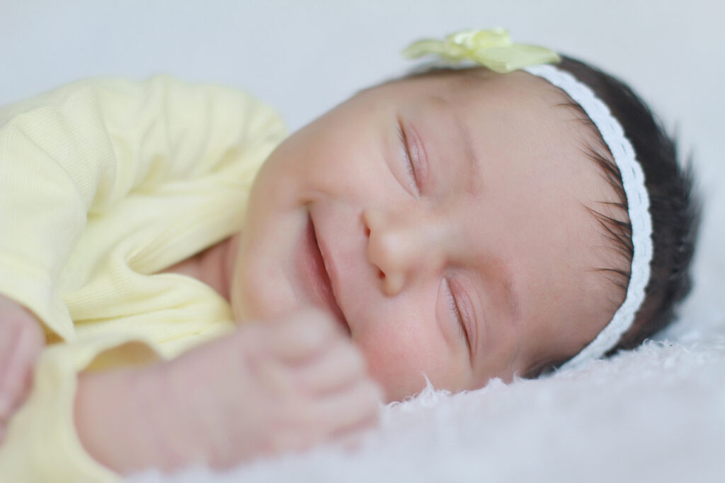 Sleeping newborn baby photographed during a professional baby photography session at FrameIt Bay Area in San Ramon